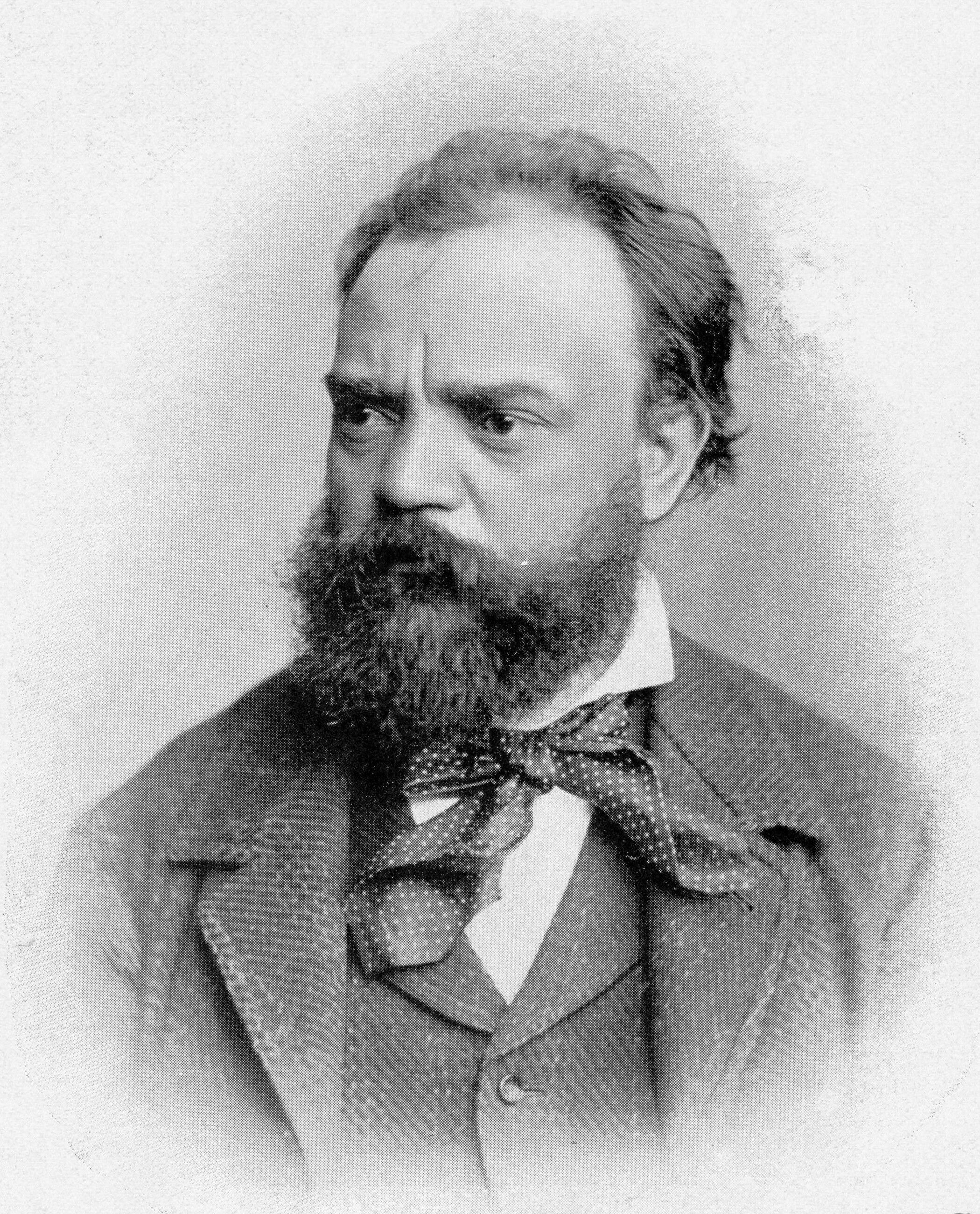 Portrait photograph of Antonín Dvořák dressed in a tweed suit.