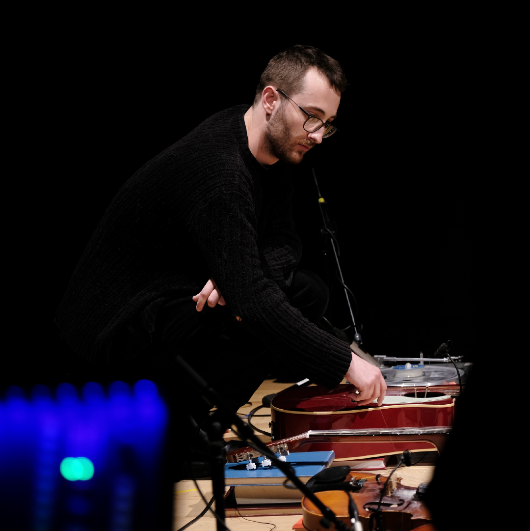 A photograph of Sam Longbottom in performance with percussion.