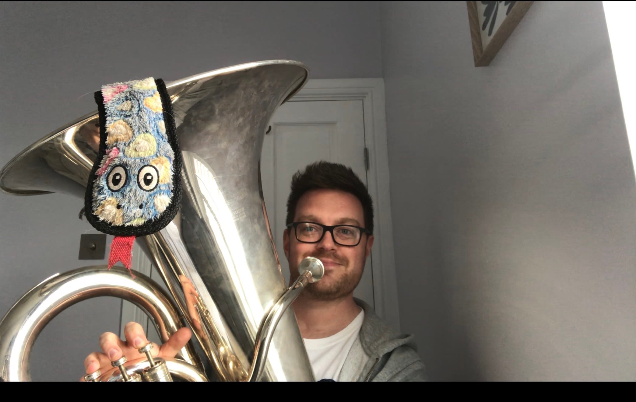 Ben Elton with a toy snake in his tuba